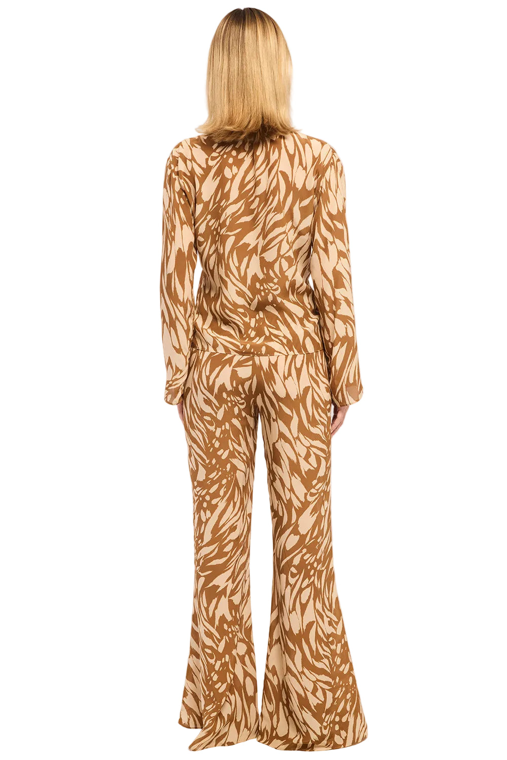 Person wearing a brown and beige patterned jumpsuit on a white background
