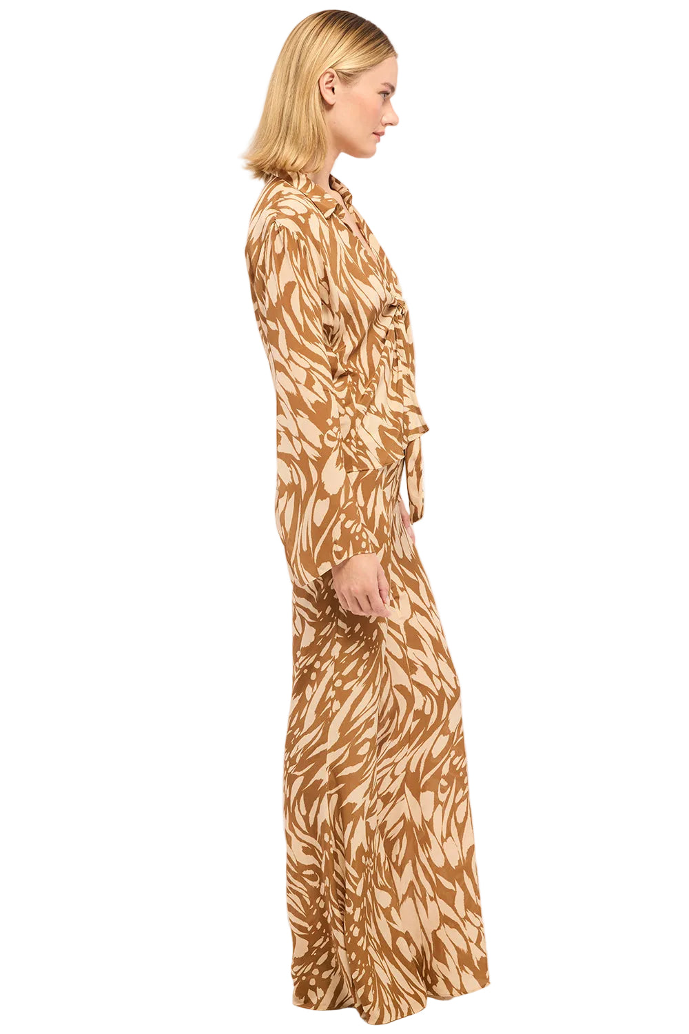 Woman wearing a long, patterned dress on a white background