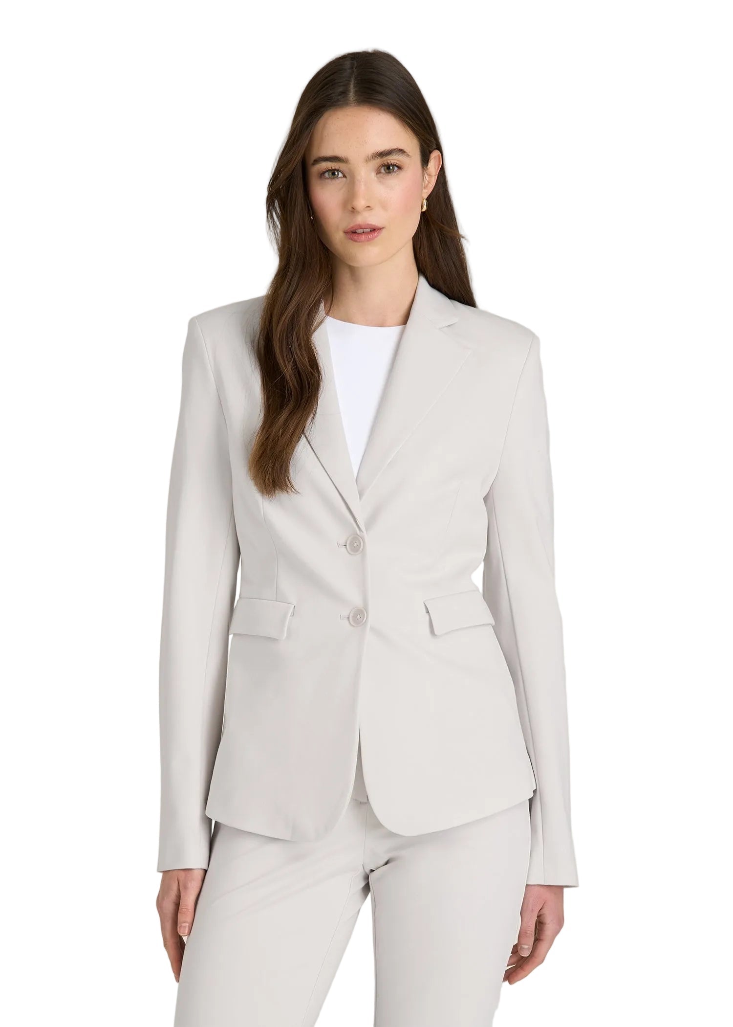 Woman wearing a light gray suit on a plain background