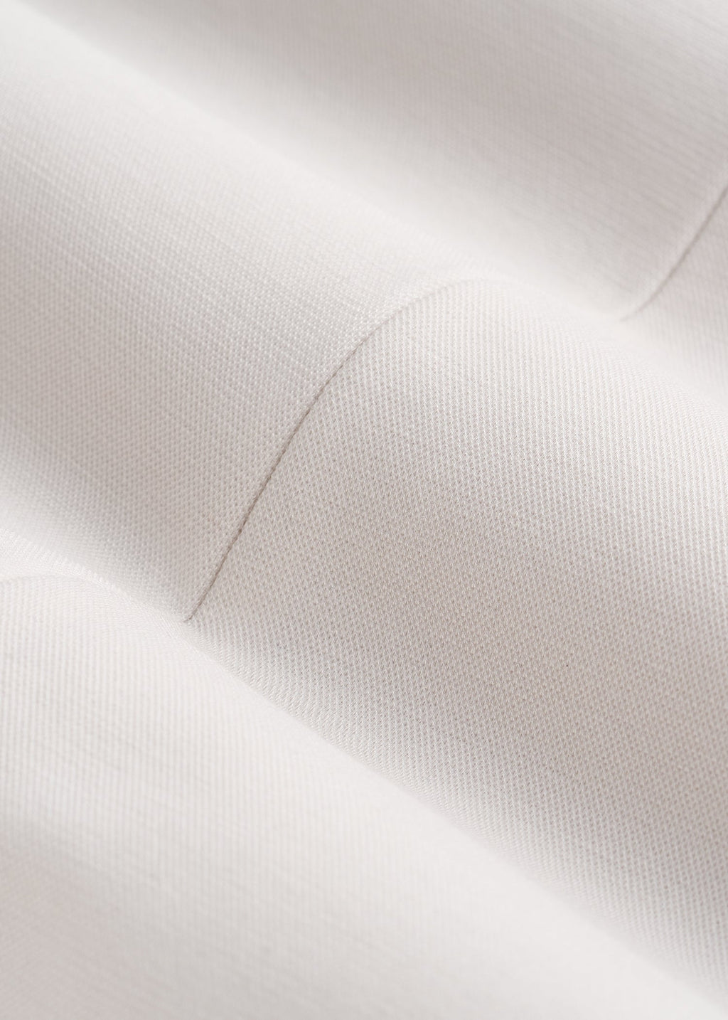 Close-up of a textured white surface with light reflections