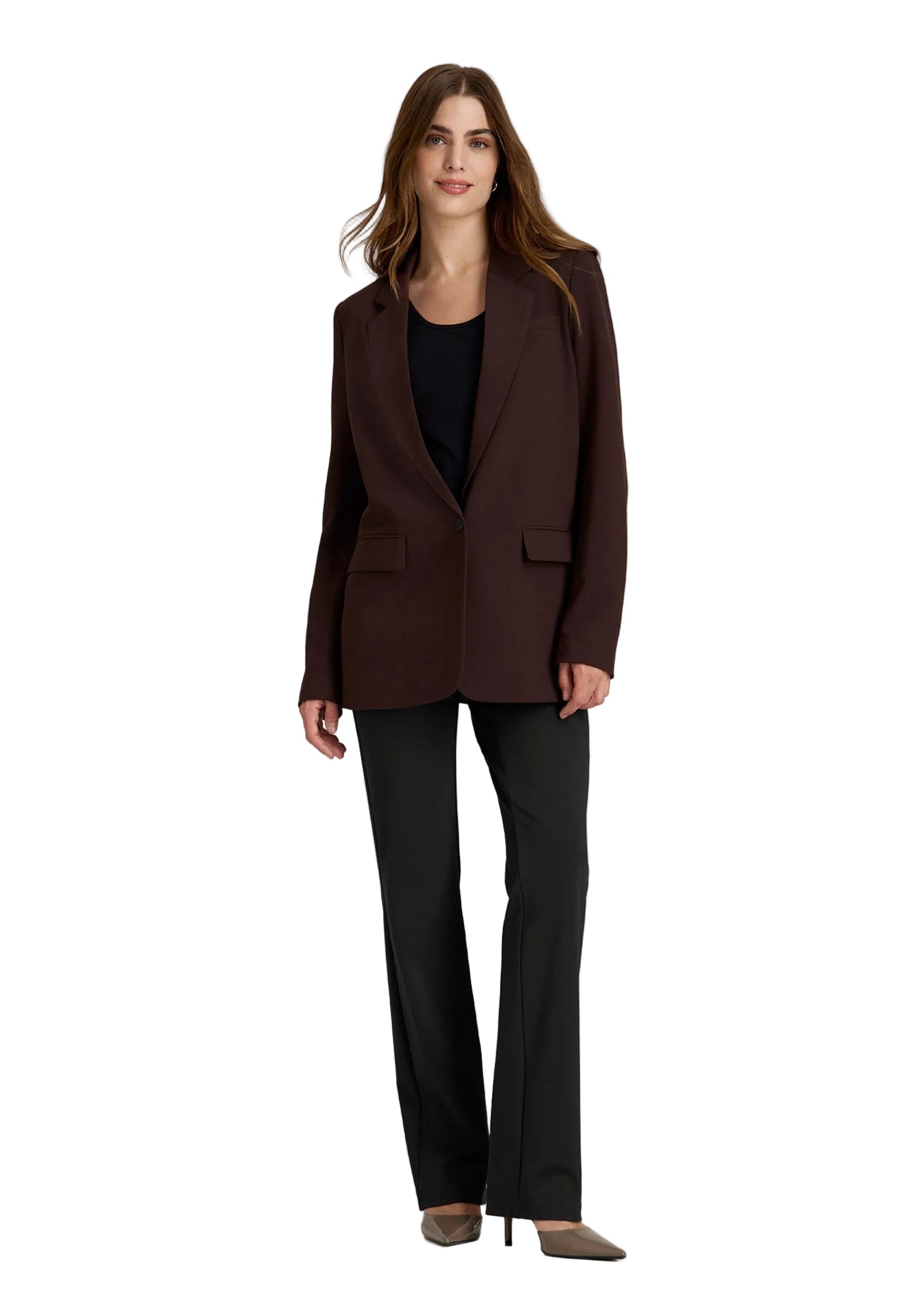 Woman wearing a brown blazer and black pants on a gray background
