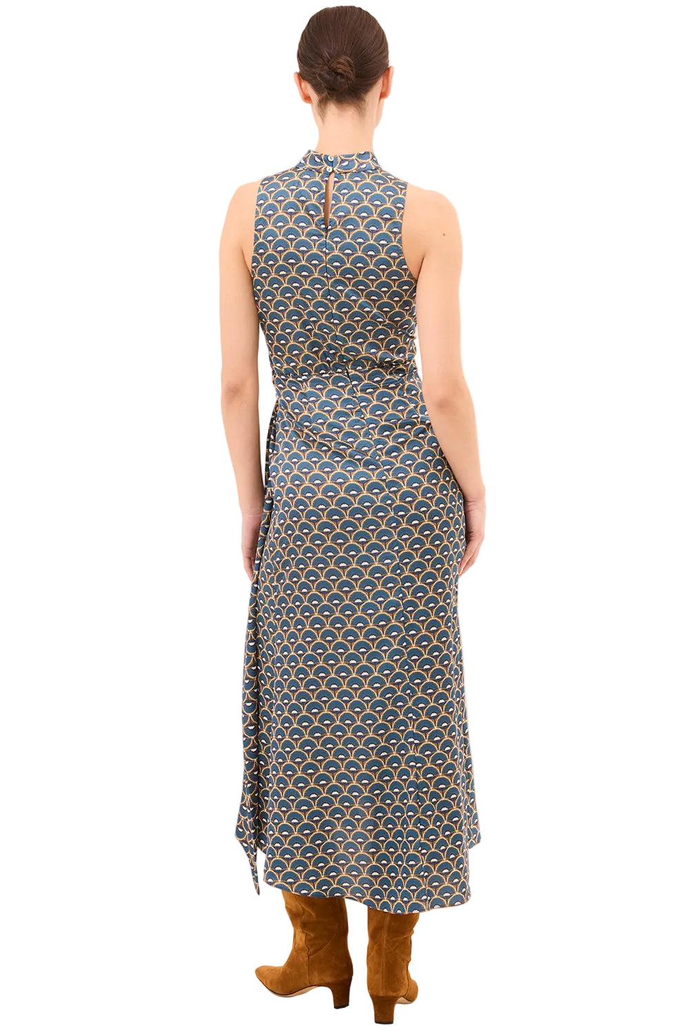 Woman wearing a sleeveless dress with a geometric pattern on a beige background