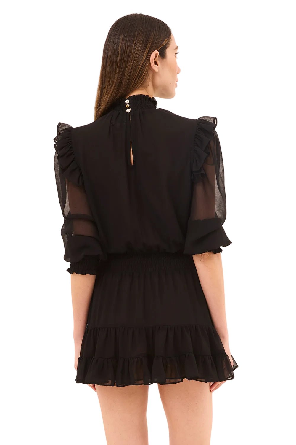 Black dress with sheer sleeves and ruffled details on a beige background