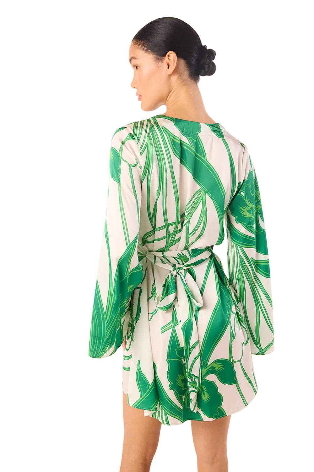 Woman wearing a green and white leaf-patterned dress on a white background