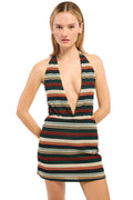 Woman wearing a colorful striped dress on a white background