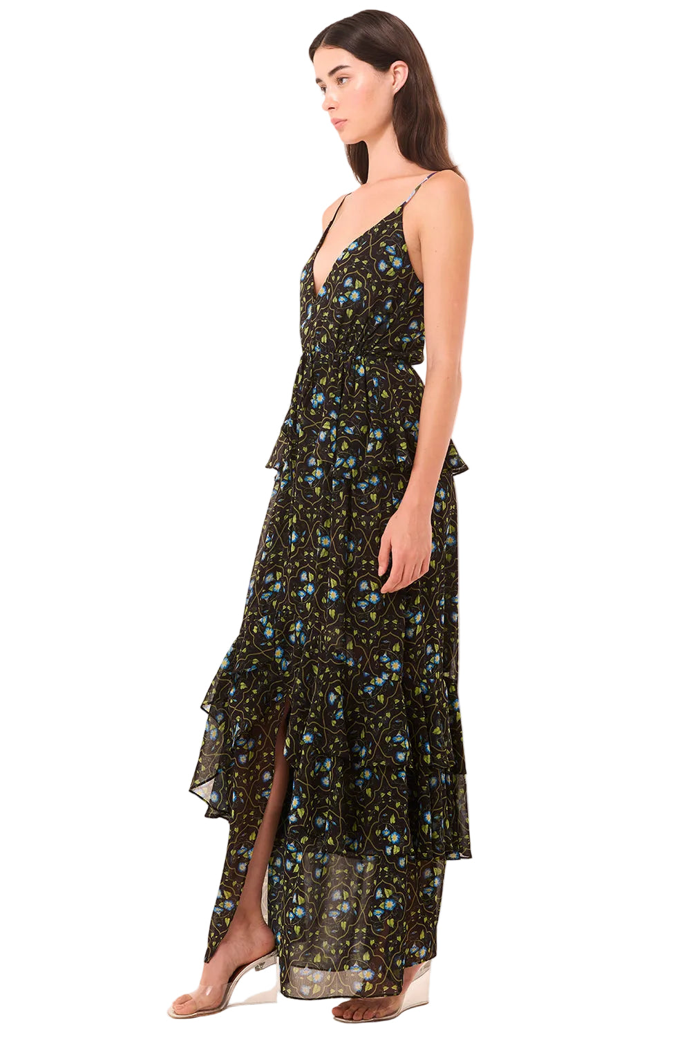 Woman wearing a floral dress with a slit on a beige background