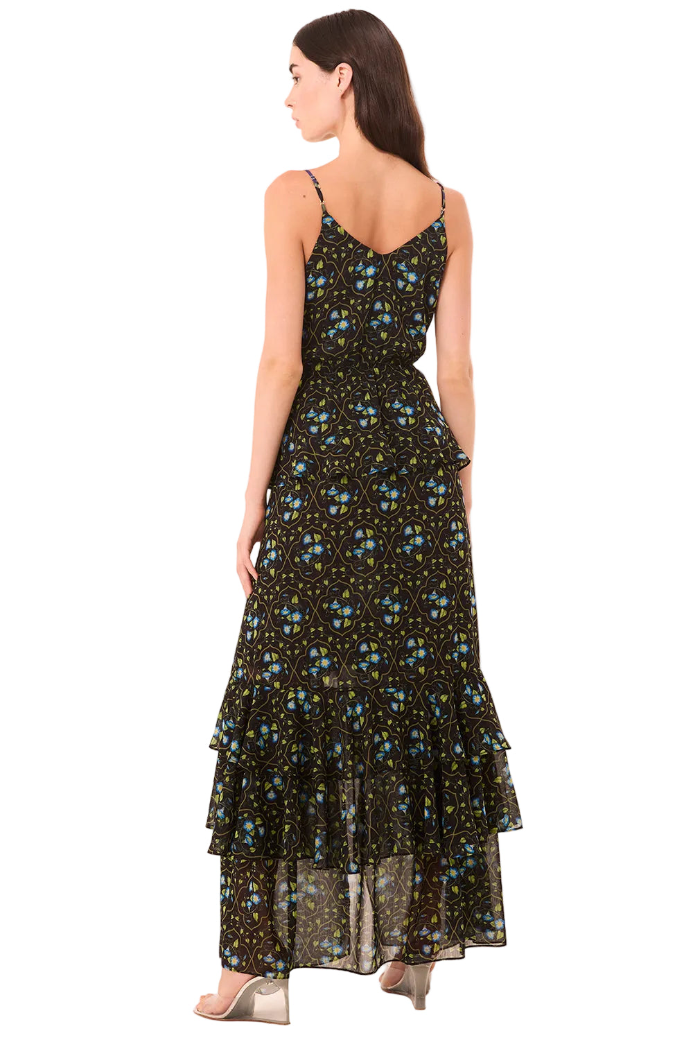 Woman wearing a black floral dress on a beige background
