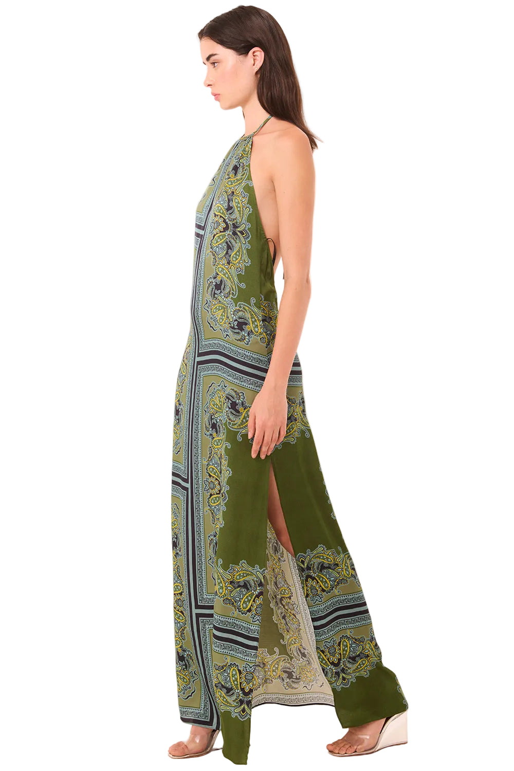 Woman wearing a green patterned dress on a white background