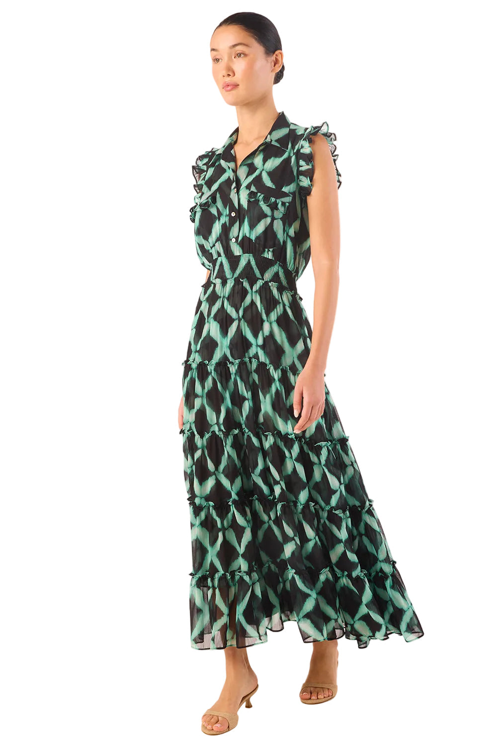 Woman wearing a green and black patterned dress on a white background