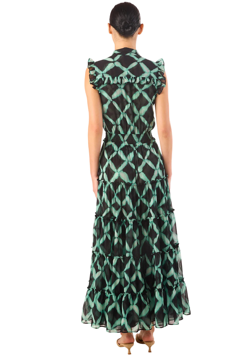Woman wearing a green and black patterned dress on a white background