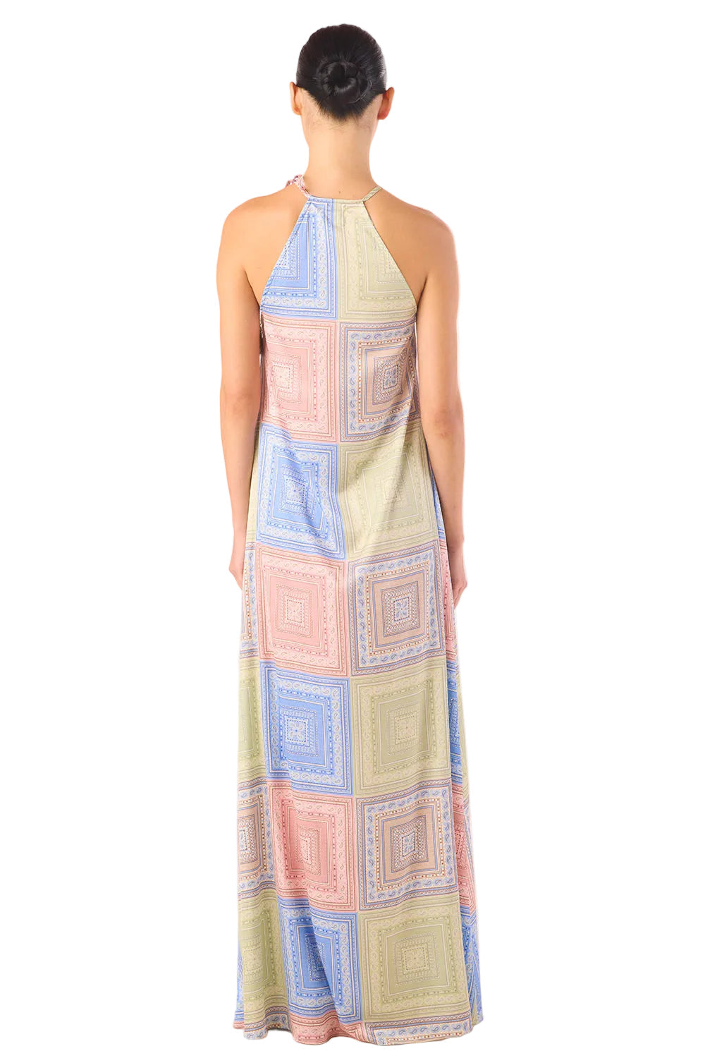 Woman wearing a colorful patterned dress on a white background