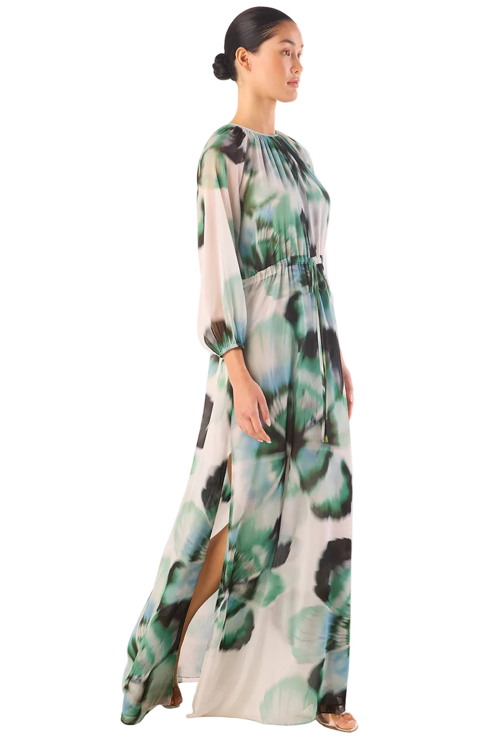 Woman wearing a long, floral-patterned dress on a white background