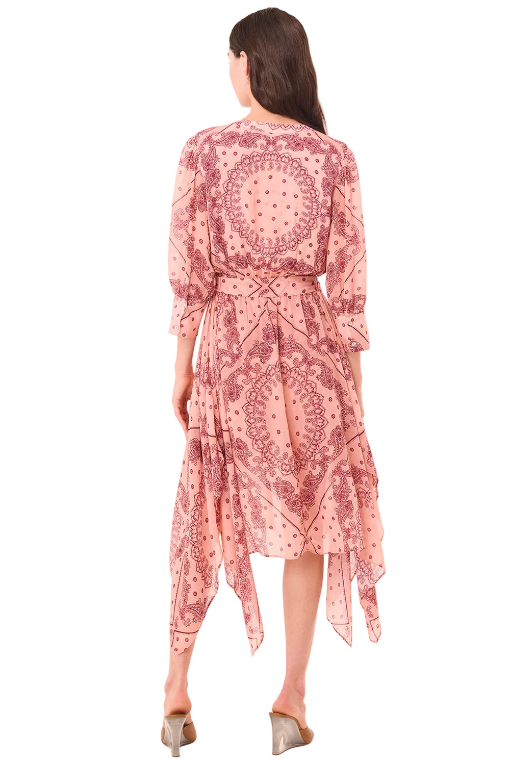 Woman wearing a pink patterned dress on a light pink background
