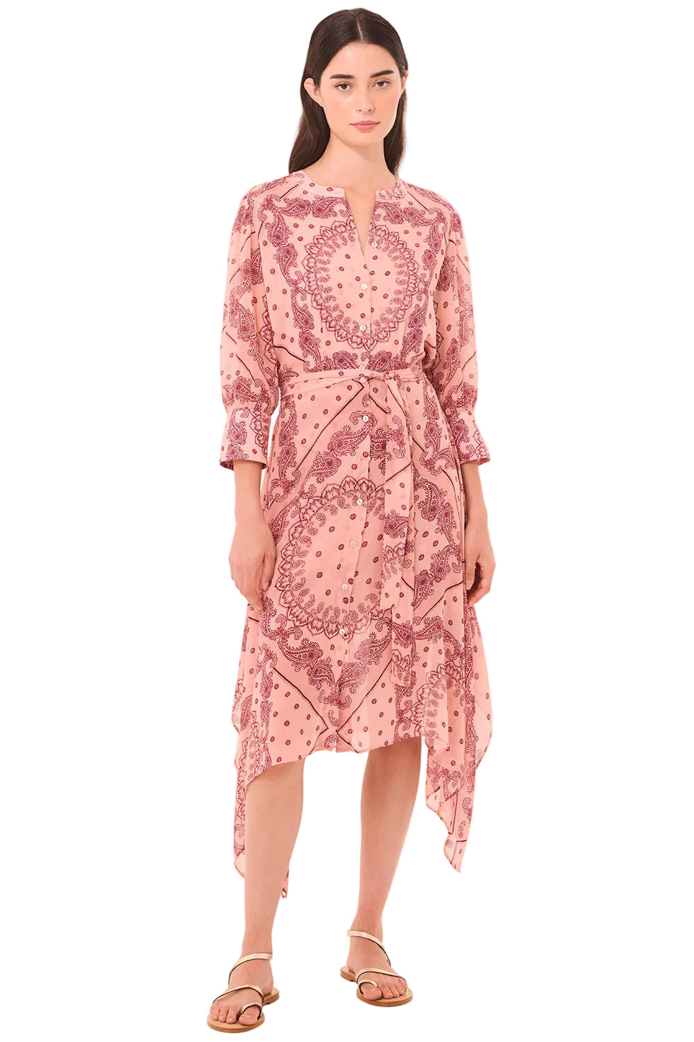 Woman wearing a pink patterned dress on a white background