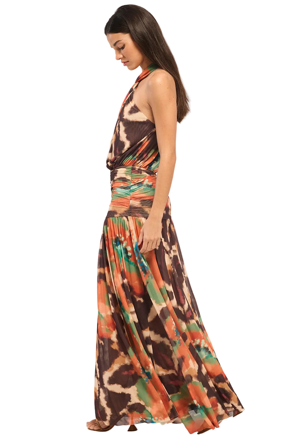 Woman wearing a colorful halter neck dress on a white background