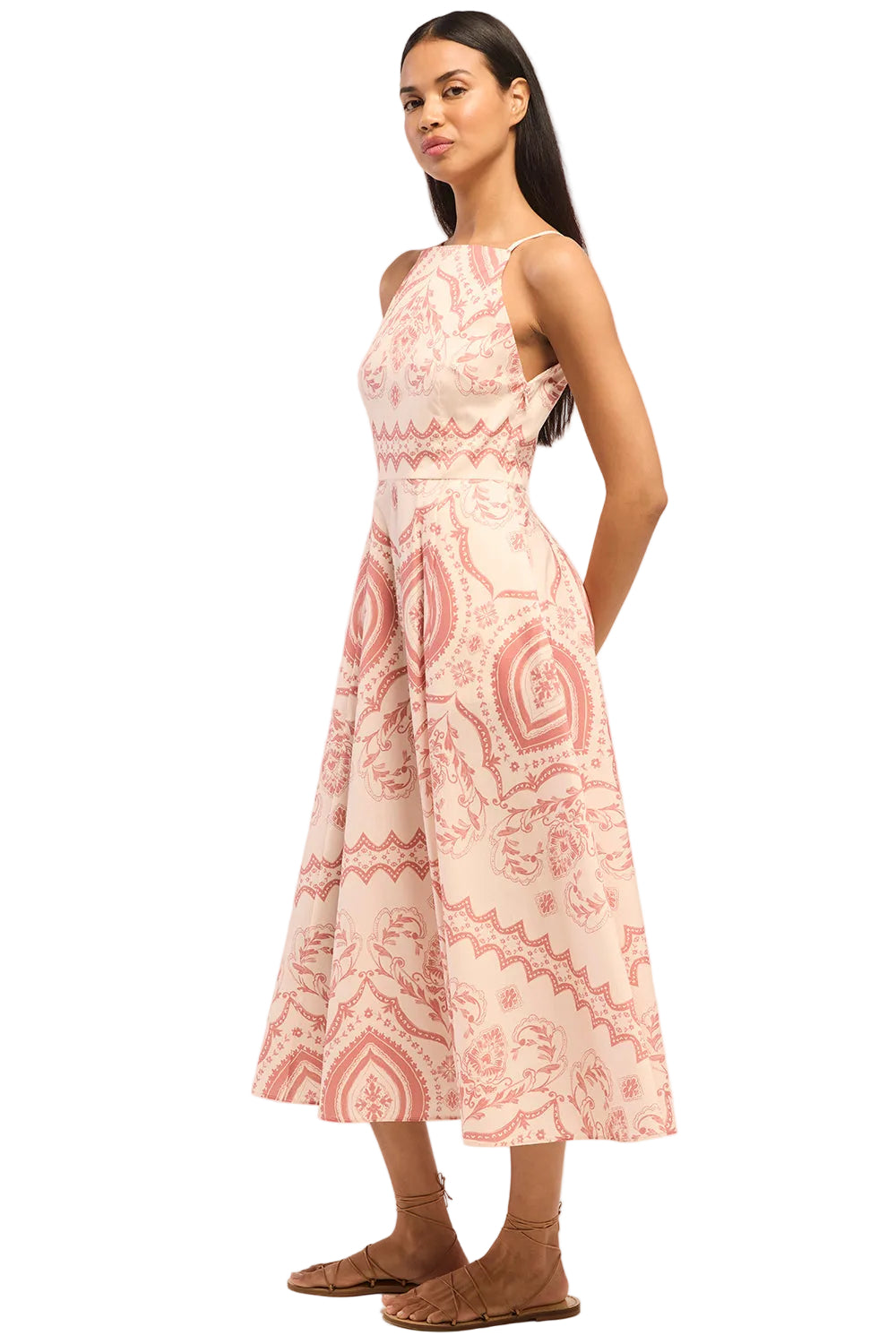 Woman wearing a pink and white patterned dress on a white background