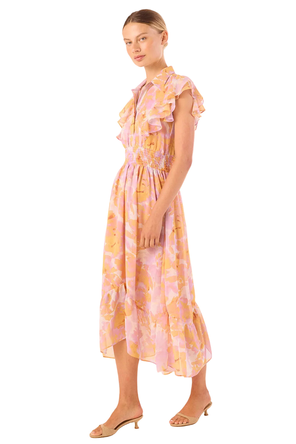 Woman wearing a pink and yellow patterned dress on a white background